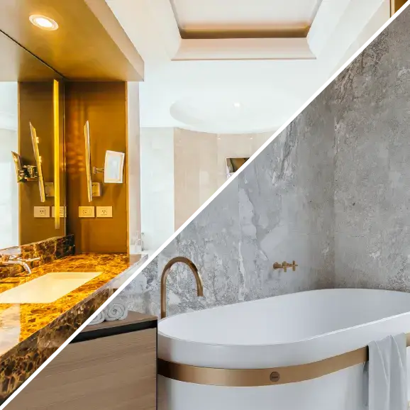 Ein luxuriöses Badezimmer mit einem beleuchteten Spiegel und einer freistehenden Badewanne mit goldenen Details.
