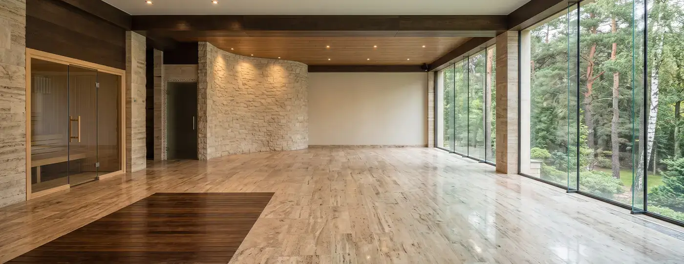 Ein weitläufiger Spa-Bereich mit Sauna und Glasfronten zum Wald hin.